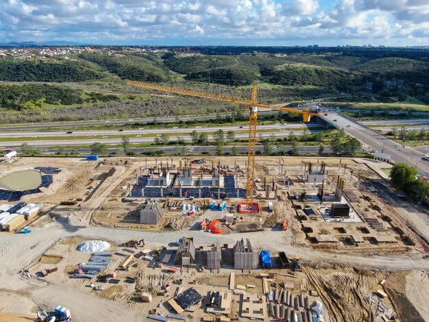 Aerial view of investors and contractors on construction site with crane. New construction site