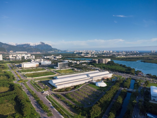 Aerial view of jacarã©pagua lagoon in rio de janeiro, brazil. residential buildings and mountains around the lake. barra da tijuca beach in the background. sunny day. sunset. drone photo.