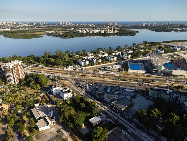 Aerial view of Jacarepagua lagoon in Rio de Janeiro Brazil Residential buildings and mountains around the lake Barra da Tijuca beach in the background Sunny day Sunset Drone photo