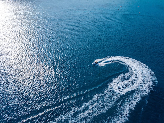Aerial view on jet ski in azure sea Water sport