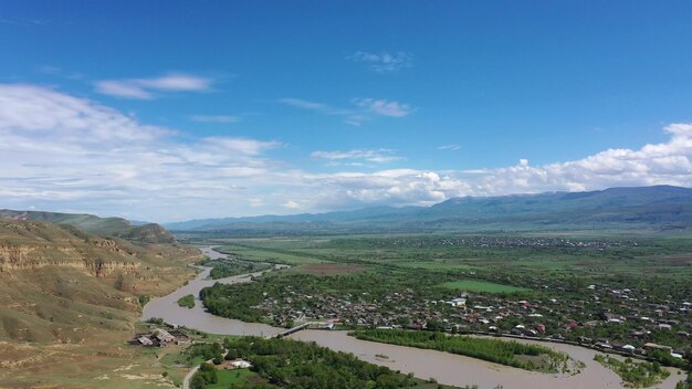 Photo aerial view on the kura river and caucasus mountains