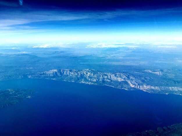 Aerial view of landscape against blue sky