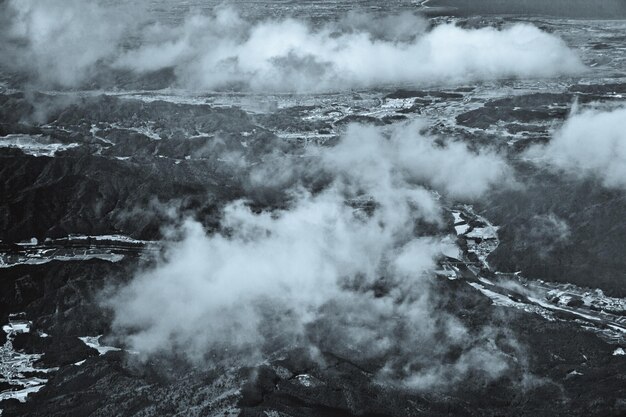 Photo aerial view of landscape against clouds