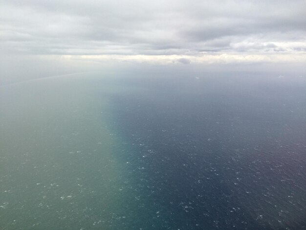 Aerial view of landscape against cloudy sky