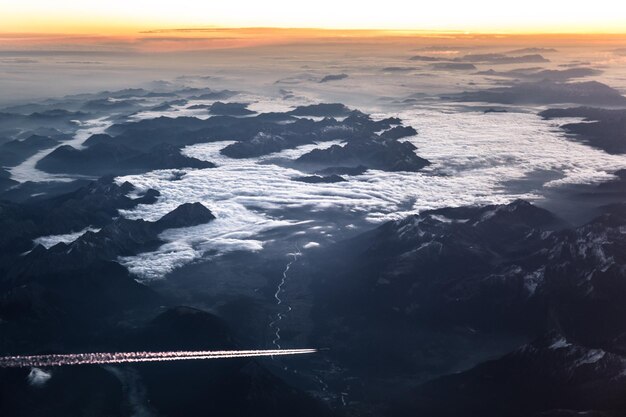 Photo aerial view of landscape against sky during sunset