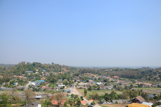 Aerial view landscape local Rim Kok village rural and Chiangrai country countryside on mountain hill of Wat Huay Pla Kang temple for thai people a foreign traveler travel visit in Chiang Rai Thailand