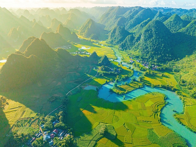 Aerial view landscape in phong nam valley in cinematic sunset an extreme scenery landscape at cao bang province vietnam with river nature green rice fields travel and landscape concept