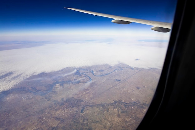 Aerial view of landscape seen through airplane window