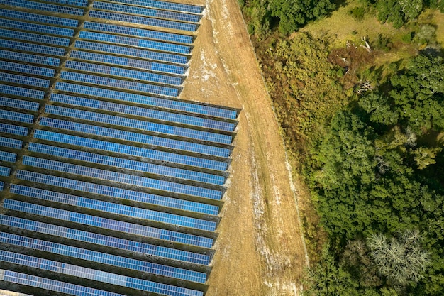 クリーンな電気エネルギーを生成するための太陽光発電パネルの列を備えた大規模で持続可能な発電所の航空写真ゼロエミッションの再生可能エネルギーの概念