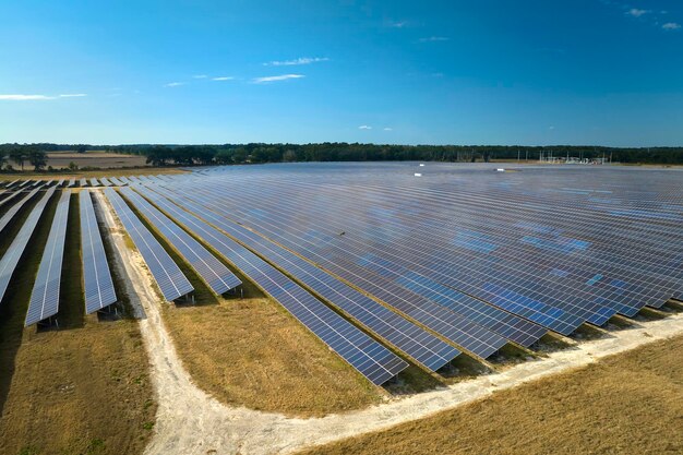 Aerial view of large sustainable electrical power plant with rows of solar photovoltaic panels
