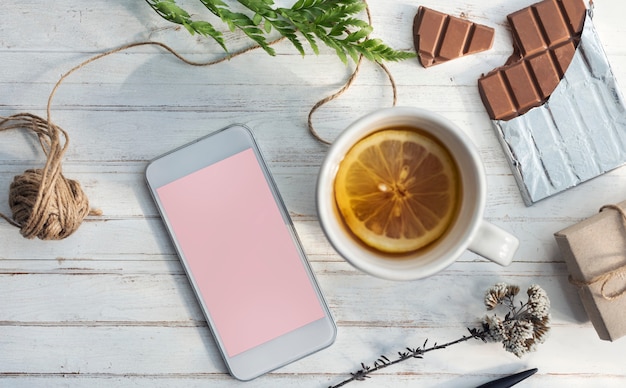 Aerial view of lemon tea and mobile phone