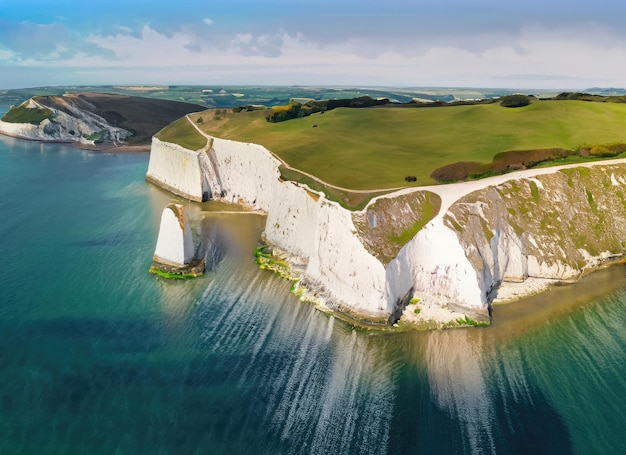 Aerial view of limestone cliffs and stacks with countryside at Old Harry Rocks in Dorset UK