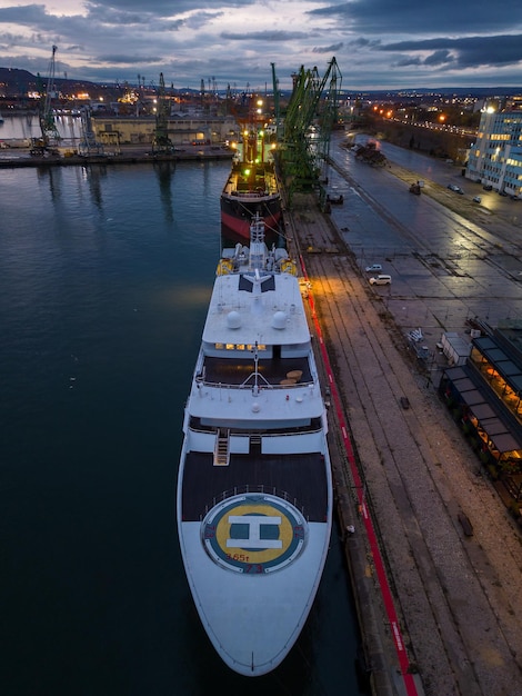 Aerial view of luxury yacht in port at night