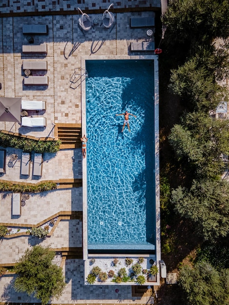 aerial view of man floating on water in swimming pool