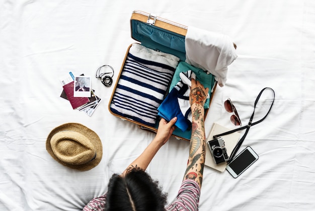 Aerial view of man packing clothes for a trip