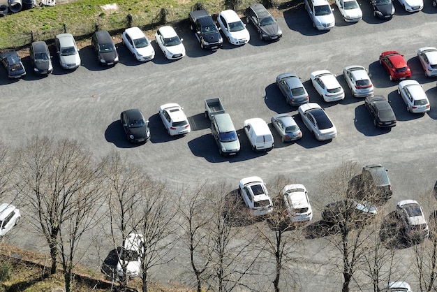 Aerial view of many colorful cars parked on parking lot