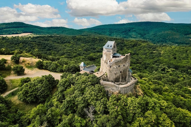 Aerial view of medieval ruined Holloko castle UNESCO world heritage site in Hungary Historical castle in Hungary Mountains