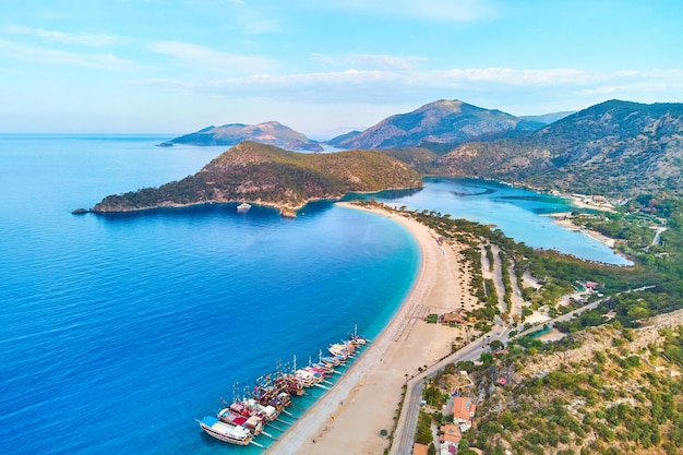 Aerial view of mediterranean sea bay with mountain sandy beach and boats at sunny day in summer Drone photo of Blue lagoon in Oludeniz Turkey