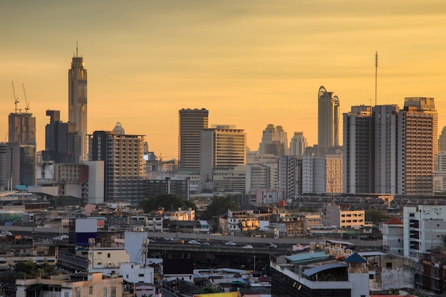 Aerial view modern office buildings in Bangkok city downtown with sunrise time