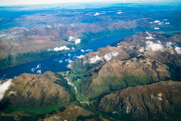 Aerial view of mountain and lake landscape from airplane above mountain near Queenstown, New Zealand