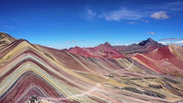 Aerial view of mountain range against blue sky