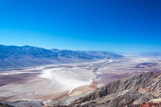 Aerial view of mountain range against blue sky