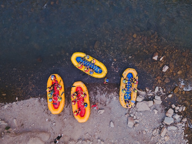 Aerial view of mountain river people rafting in creek. extreme vitality