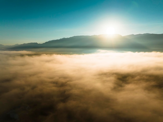 Aerial view of mountains in orange clouds at sunrise in summer