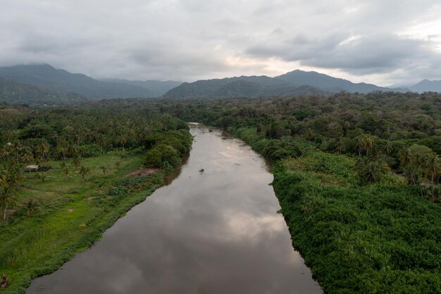 Aerial view of nature hills and beach of Los Naranjos in Santa Marta by Tayrona National Park in Colombia