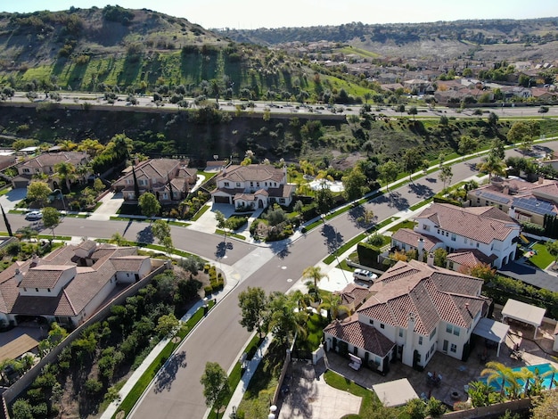 Photo aerial view of neighborhood with residential subdivision houses and small road in chula vista