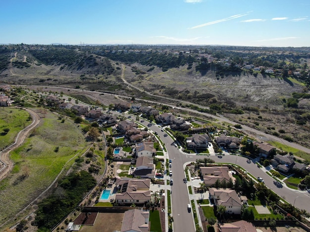 Aerial view of neighborhood with residential subdivision houses and small road in Chula Vista