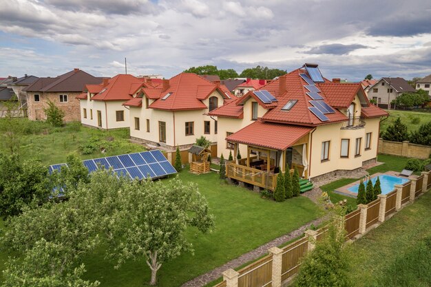 Aerial view of a new autonomous house with solar panels and water heating radiators on the roof