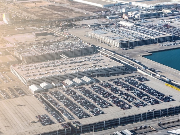 Aerial view new cars lined up at distribution centre. Cars distribution centre for import and export.