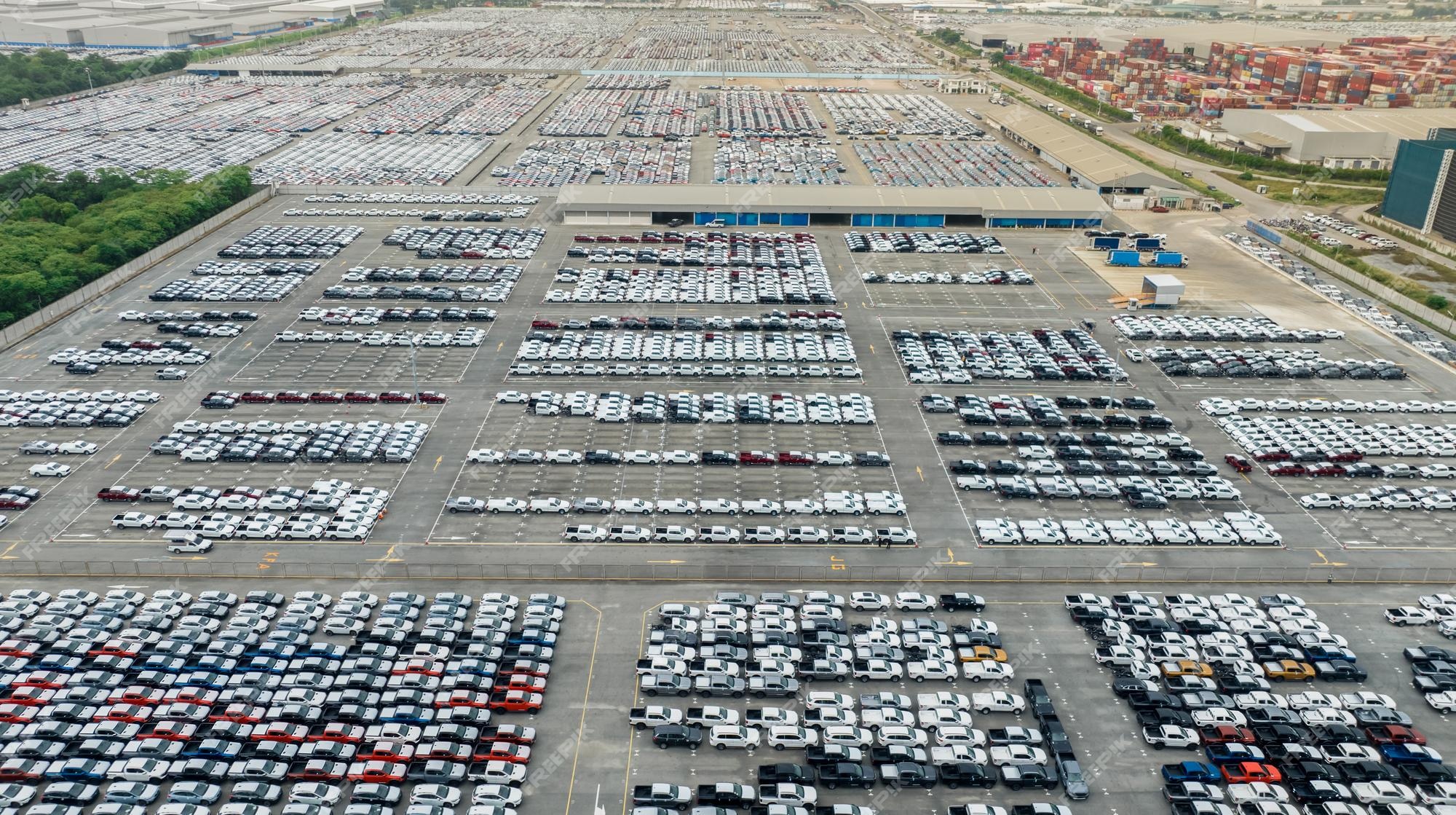 Premium Photo Aerial view of new cars stock at factory parking lot