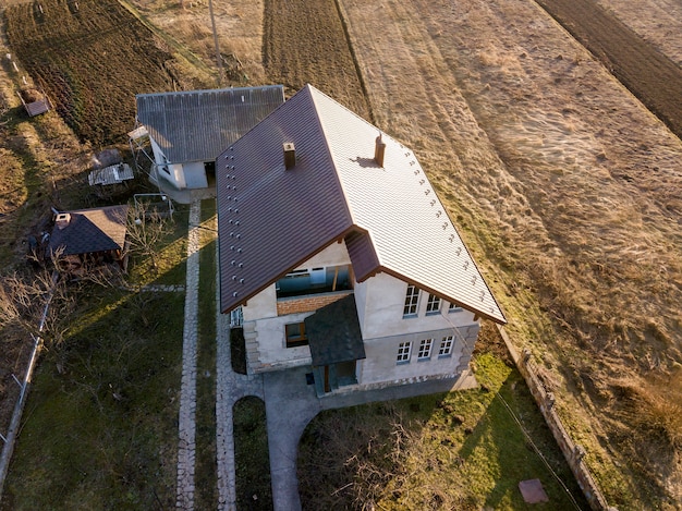 Aerial view of new residential house cottage with shingle roof.