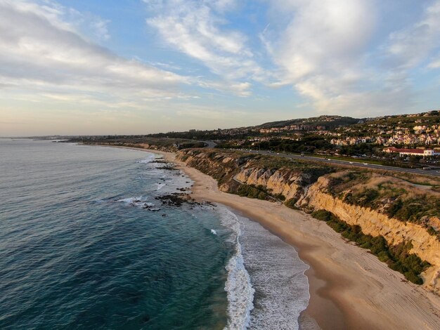 Aerial view of Newport Beach small road next to the cliff during sunset twilight