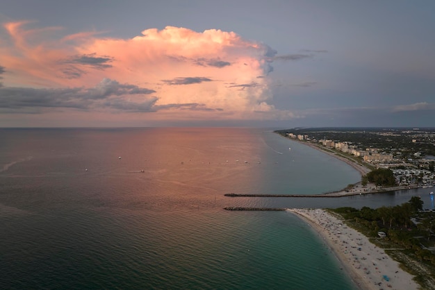 Aerial view of Nokomis beach and South and North Jetty in Sarasota County USA Many people enjoing vacation time swimming in gulf water and relaxing on warm Florida sun at sunset