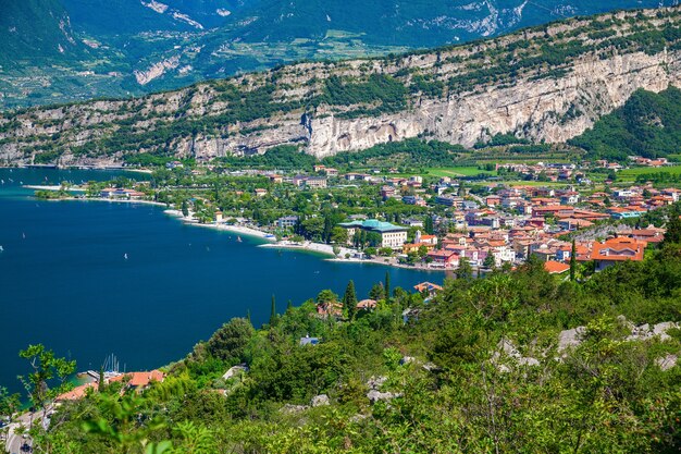 Aerial view on the northern part of garda lake with mountains and small village torbole, italy