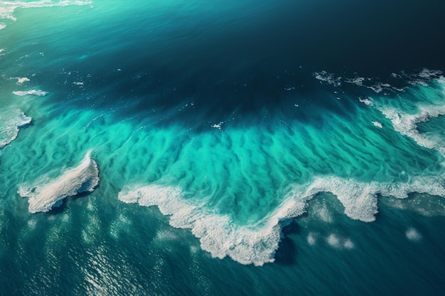 An aerial view of the ocean with a blue ocean and a white sand beach.