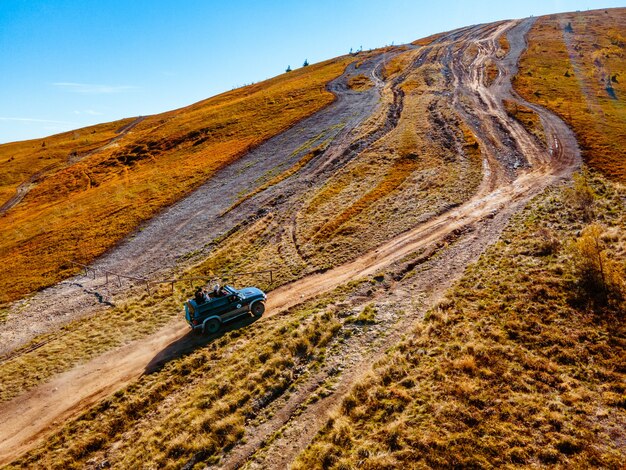 Aerial view of off road attraction road to the top of carpathian mountains copy space autumn season