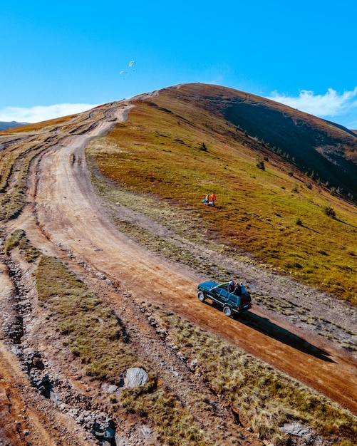 Aerial view of off road attraction road to the top of carpathian mountains copy space autumn season