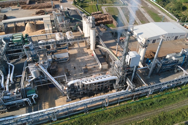 Aerial view of oil and gas refining petrochemical factory with tall refinery plant manufacture structure