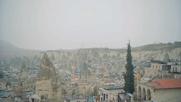 Photo aerial view of old cappadocia city in a morning haze action old rock formations and buildings of a