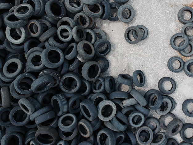 Aerial view of old tires. Many car and truck tires on dump site from above. Aerial view