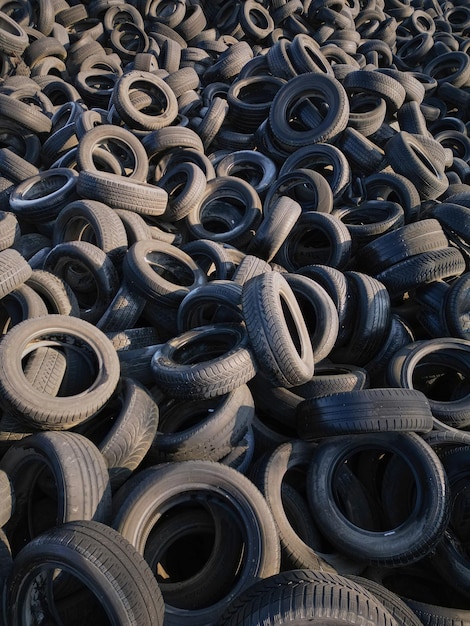 Aerial view of old tires Many car and truck tires on dump site from above