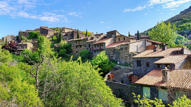 Aerial view of old town in the mountains with stone houses and green trees. Patones de Arriba Madrid