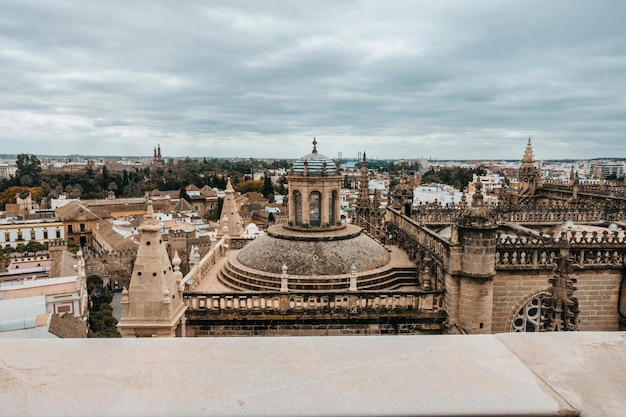 Aerial view of one of domes of cathedral of Seville on cloudy day