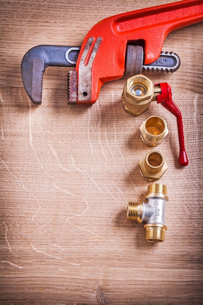 Aerial View Organized Copysoace Monkey Wrench And Brass Pipe Connectors On Wooden Board