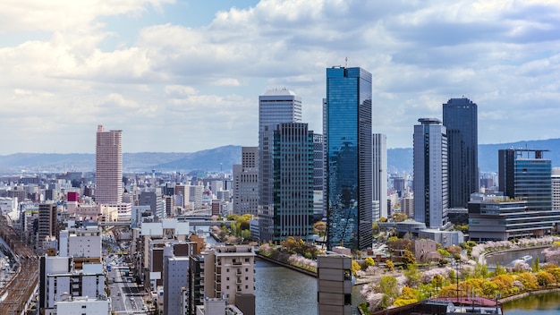 空の建物から大阪市の空撮。混雑した高層ビルのオフィスやアパートのある街並みの鳥瞰図。日本地区のスカイラインからのパノラマ都市屋上ビュー