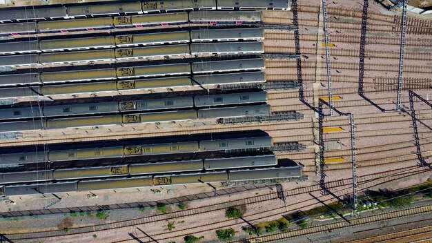 Aerial view over passenger trains in rows at a station